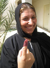 Iraqi woman displays inked finger